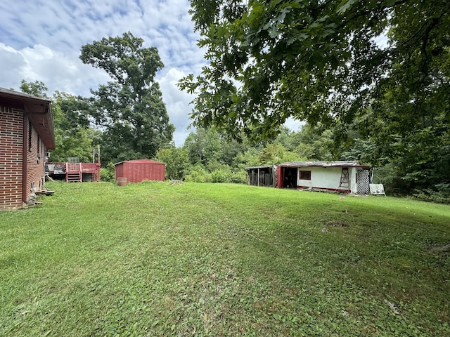 2168 Jefferson Rd, Smithville, TN 37166 - view of green lawn featuring a shed, an outbuilding, and a wooden deck