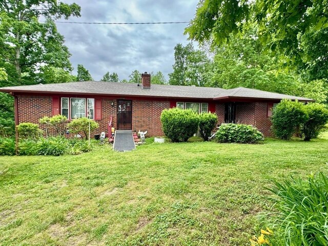 2168 Jefferson Rd, Smithville, TN 37166 - view of front of house with brick siding, a front lawn, and a chimney