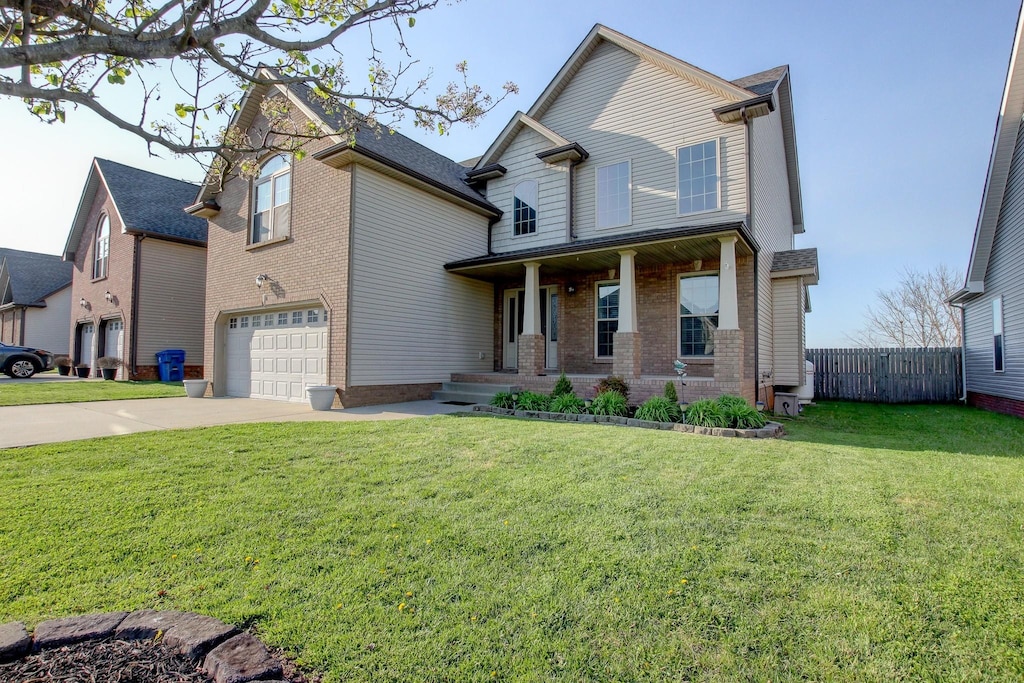 view of front facade with an attached garage, concrete driveway, a porch, and brick siding