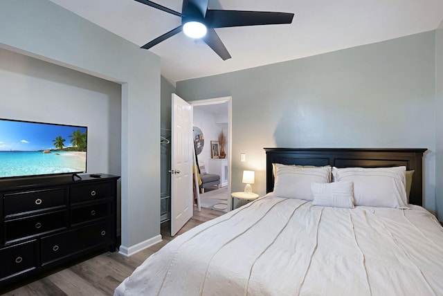 bedroom with wood finished floors, baseboards, and a ceiling fan