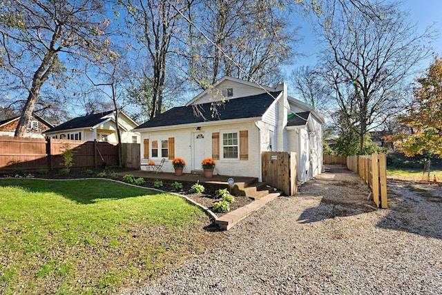 view of front of property featuring brick siding and a chimney