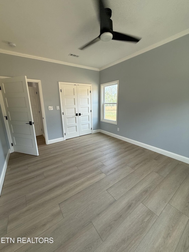 222 Ten Mile Ln, Ten Mile, TN 37880 - unfurnished bedroom featuring wood finished floors, crown molding, baseboards, a closet, and ceiling fan