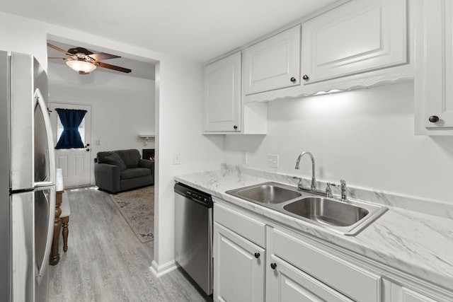 1129 W Main St Unit 21, Franklin, TN 37064 - kitchen with stainless steel appliances, a sink, light wood-style floors, and white cabinetry