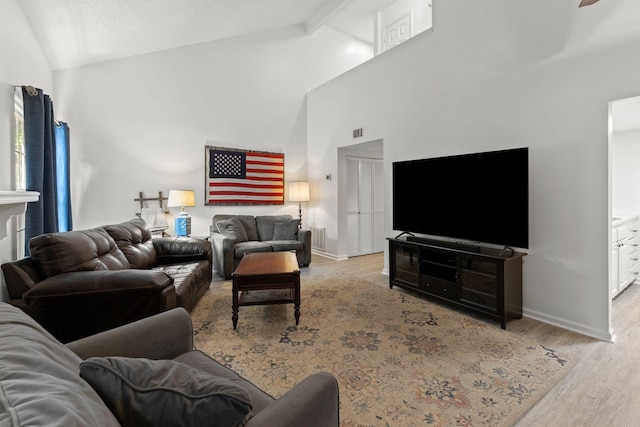 1129 W Main St Unit 21, Franklin, TN 37064 - living room with wood finished floors, beam ceiling, baseboards, and high vaulted ceiling