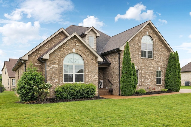 1403 Wade Hampton Ct, Lebanon, TN 37087 - view of front of property featuring a front lawn, brick siding, central air condition unit, and roof with shingles