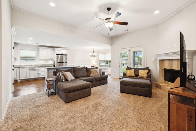 1403 Wade Hampton Ct, Lebanon, TN 37087 - carpeted living area with recessed lighting, a ceiling fan, a tile fireplace, ornamental molding, and a chandelier
