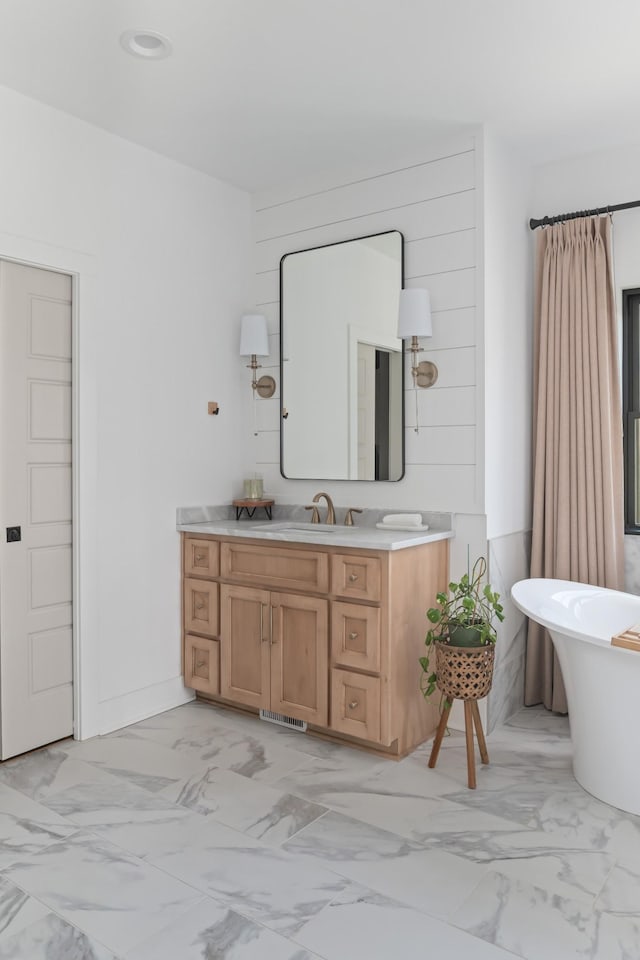 7361 Liberty Rd, Fairview, TN 37062 - bathroom with marble look tile flooring, vanity, and a freestanding bath