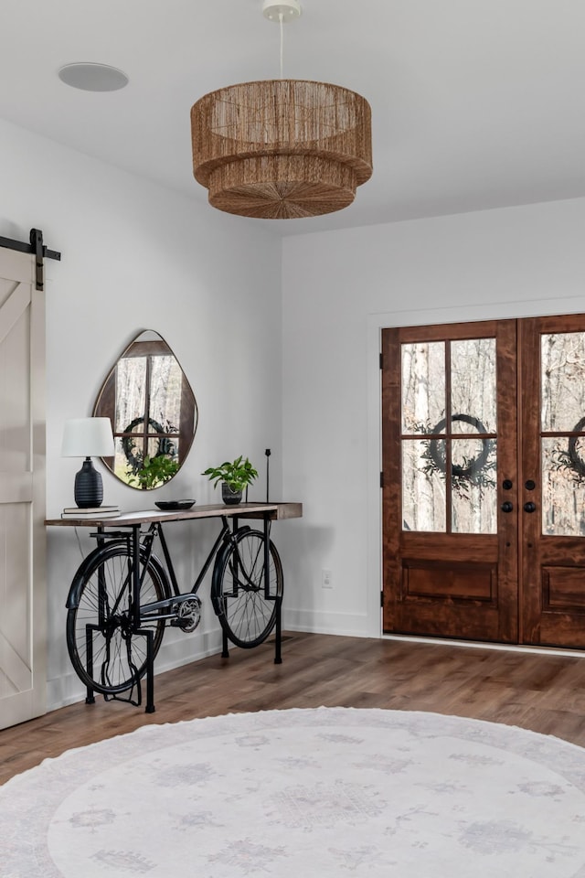 7361 Liberty Rd, Fairview, TN 37062 - foyer with a barn door, wood finished floors, french doors, and baseboards