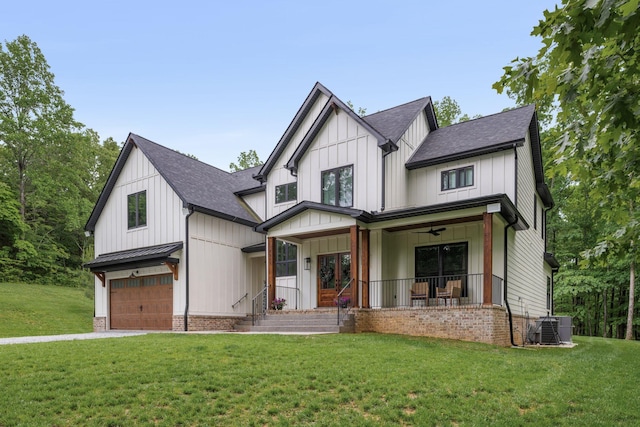 7361 Liberty Rd, Fairview, TN 37062 - modern farmhouse style home featuring a garage, covered porch, roof with shingles, central AC unit, and a front yard