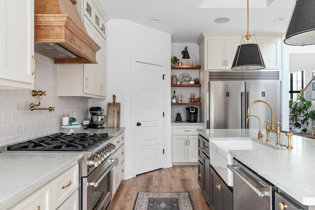7361 Liberty Rd, Fairview, TN 37062 - kitchen featuring high quality appliances, dark wood-style flooring, white cabinets, custom exhaust hood, and tasteful backsplash