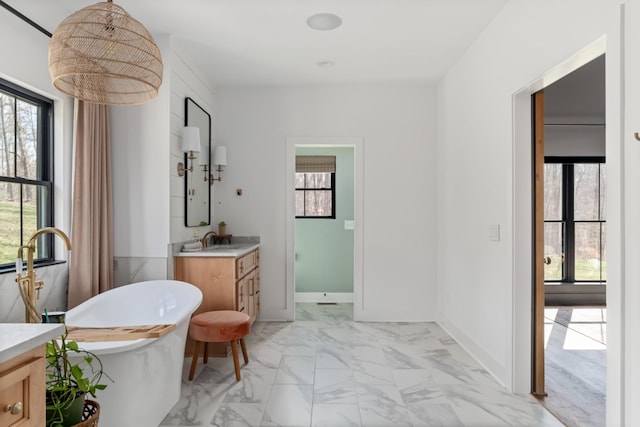 7361 Liberty Rd, Fairview, TN 37062 - bathroom with vanity, marble look tile flooring, and a freestanding bath