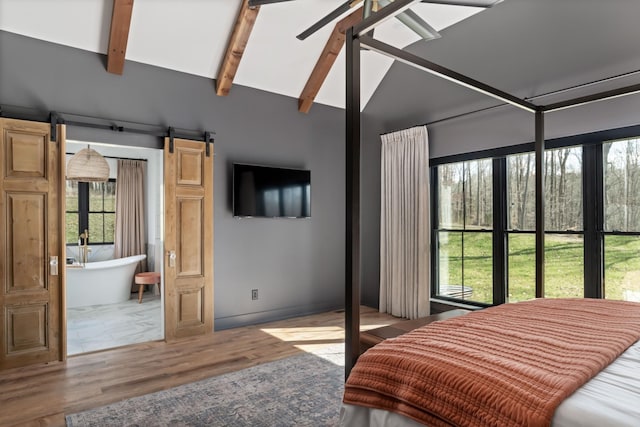 7361 Liberty Rd, Fairview, TN 37062 - bedroom featuring wood finished floors, multiple windows, and a barn door