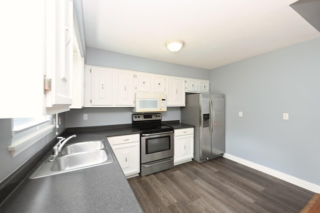 349 Marrell St, Gallatin, TN 37066 - kitchen with appliances with stainless steel finishes, a sink, dark countertops, white cabinetry, and dark wood-style floors