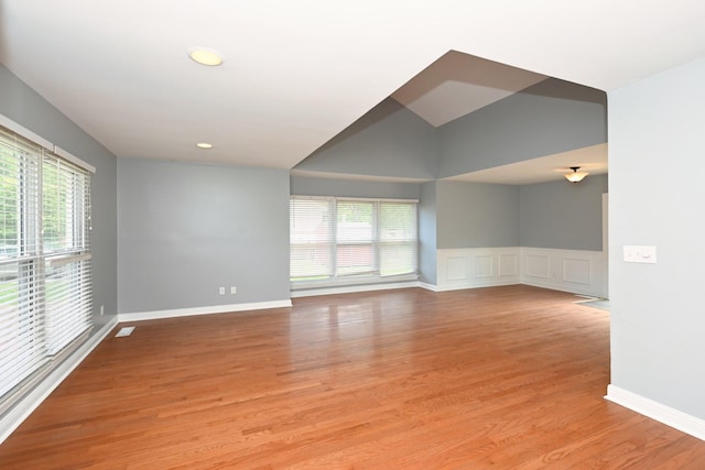 349 Marrell St, Gallatin, TN 37066 - empty room with healthy amount of natural light, light wood finished floors, a wainscoted wall, a decorative wall, and recessed lighting