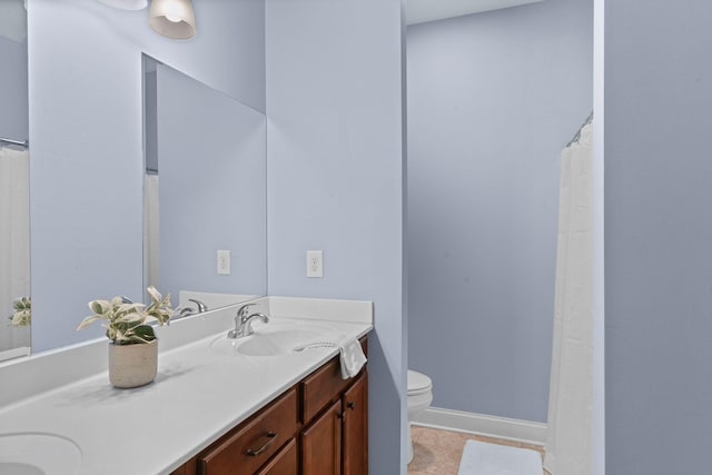 703 Asbury Hawn Dr, Lebanon, TN 37087 - bathroom with toilet, double vanity, baseboards, and tile patterned floors