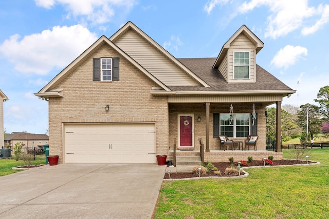 703 Asbury Hawn Dr, Lebanon, TN 37087 - view of front facade with covered porch, brick siding, concrete driveway, central AC unit, and an attached garage