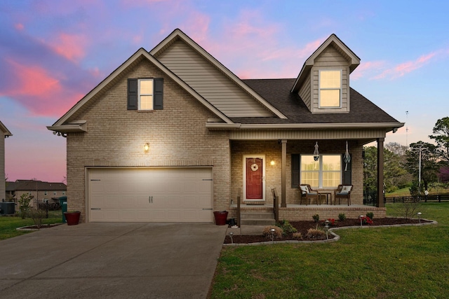 703 Asbury Hawn Dr, Lebanon, TN 37087 - view of front of house featuring a porch, concrete driveway, brick siding, an attached garage, and central AC