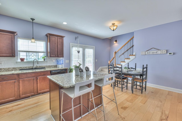 703 Asbury Hawn Dr, Lebanon, TN 37087 - kitchen with a sink, light wood-style floors, plenty of natural light, tasteful backsplash, and recessed lighting