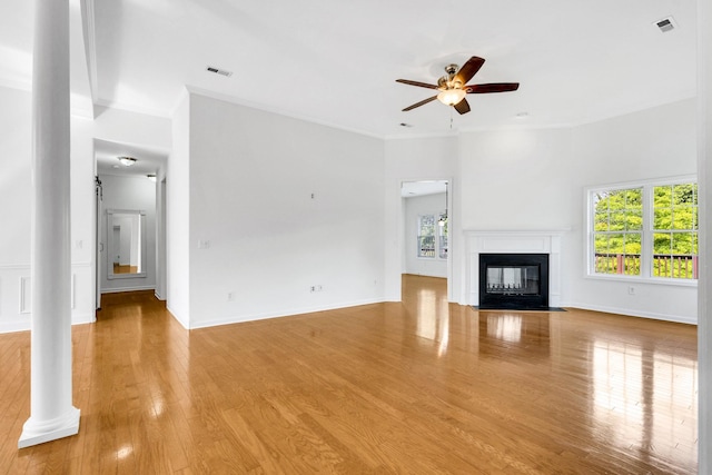 3015 Carpenters Pass, Spring Hill, TN 37174 - unfurnished living room featuring ceiling fan, light wood-style flooring, a fireplace with flush hearth, ornamental molding, and baseboards