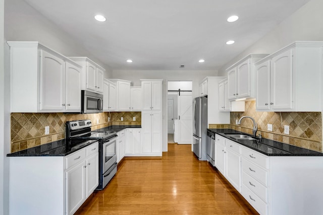 3015 Carpenters Pass, Spring Hill, TN 37174 - kitchen featuring stainless steel appliances, a sink, white cabinetry, wood finished floors, and recessed lighting
