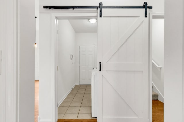 3015 Carpenters Pass, Spring Hill, TN 37174 - hallway featuring a barn door and light tile patterned floors