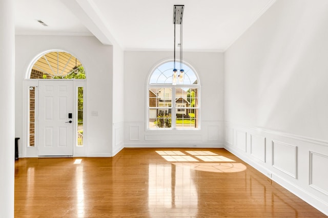 3015 Carpenters Pass, Spring Hill, TN 37174 - foyer featuring wood-type flooring, ornamental molding, a wainscoted wall, and a decorative wall