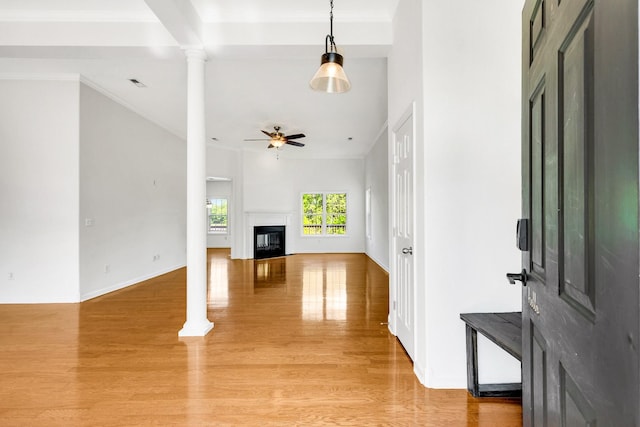 3015 Carpenters Pass, Spring Hill, TN 37174 - unfurnished living room with decorative columns, ceiling fan, light wood finished floors, a glass covered fireplace, and crown molding