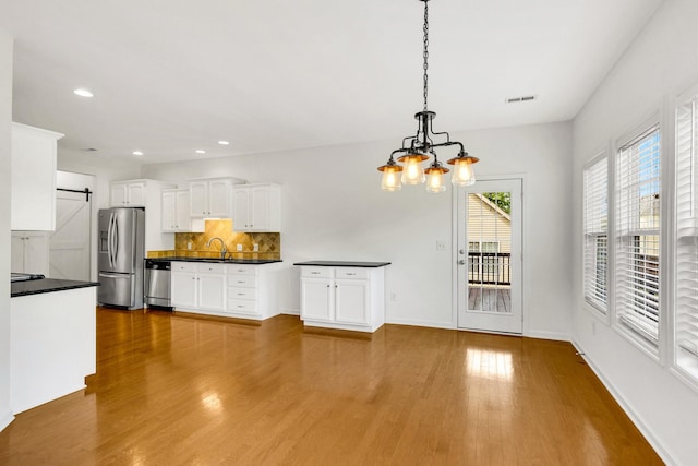 3015 Carpenters Pass, Spring Hill, TN 37174 - kitchen with appliances with stainless steel finishes, a chandelier, dark countertops, a sink, and white cabinetry