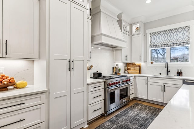 5012 Toll Road Ct, Thompsons Station, TN 37179 - kitchen with double oven range, custom range hood, a sink, white cabinets, and recessed lighting