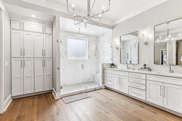 5012 Toll Road Ct, Thompsons Station, TN 37179 - bathroom featuring a chandelier, a marble finish shower, wood finished floors, double vanity, and recessed lighting