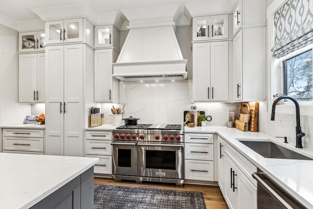 5012 Toll Road Ct, Thompsons Station, TN 37179 - kitchen with stainless steel appliances, a sink, premium range hood, dark wood-style floors, and white cabinetry