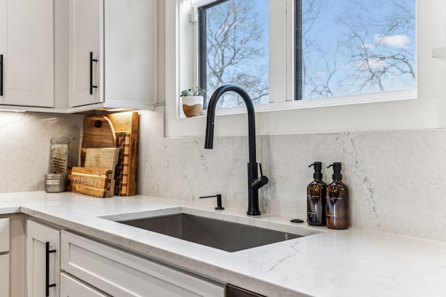 5012 Toll Road Ct, Thompsons Station, TN 37179 - kitchen featuring a sink, decorative backsplash, white cabinetry, and light stone countertops