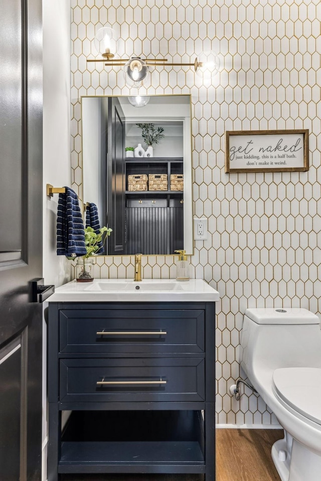 5012 Toll Road Ct, Thompsons Station, TN 37179 - half bathroom with tile walls, vanity, toilet, wood finished floors, and tasteful backsplash