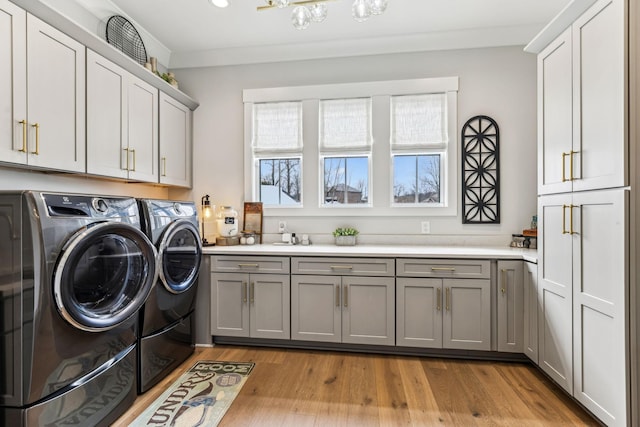 5012 Toll Road Ct, Thompsons Station, TN 37179 - clothes washing area featuring cabinet space, independent washer and dryer, and light wood-style floors