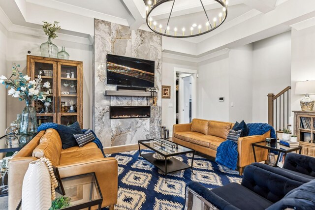 5012 Toll Road Ct, Thompsons Station, TN 37179 - living room with a premium fireplace, crown molding, a chandelier, baseboards, and wood finished floors
