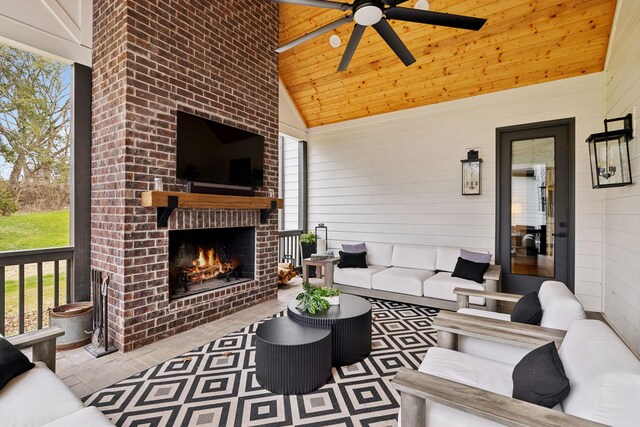 5012 Toll Road Ct, Thompsons Station, TN 37179 - living area with plenty of natural light, a ceiling fan, wood walls, an outdoor brick fireplace, and wooden ceiling