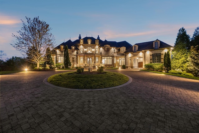 513 King Richards Ct, Franklin, TN 37067 - french country home featuring curved driveway, french doors, and stone siding