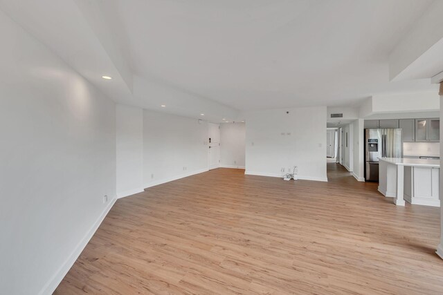 900 19th Ave S Unit 508, Nashville, TN 37212 - unfurnished living room with recessed lighting, light wood-type flooring, and baseboards
