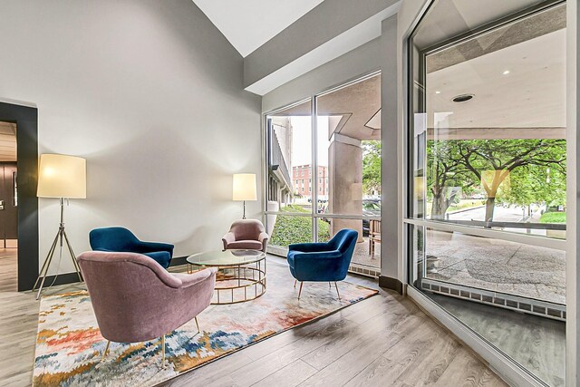 900 19th Ave S Unit 508, Nashville, TN 37212 - sitting room featuring wood finished floors, baseboards, and high vaulted ceiling