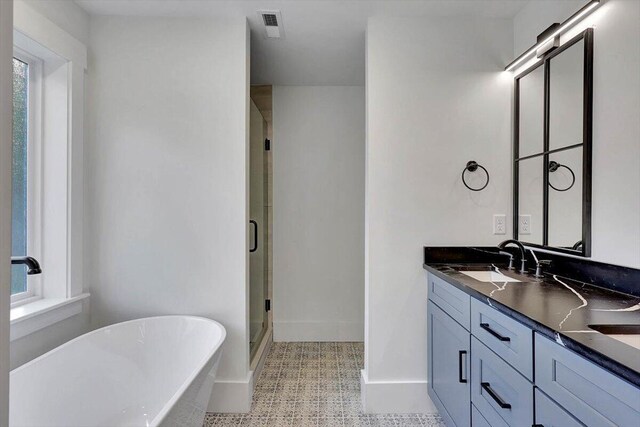 7592 Grasshopper Rd, Georgetown, TN 37336 - bathroom featuring a stall shower, vanity, a freestanding bath, baseboards, and tile patterned floors