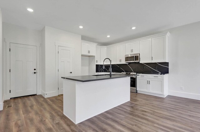 7592 Grasshopper Rd, Georgetown, TN 37336 - kitchen featuring stainless steel appliances, dark countertops, dark wood-style flooring, and recessed lighting