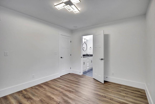 7592 Grasshopper Rd, Georgetown, TN 37336 - unfurnished room featuring baseboards, wood finished floors, and a sink