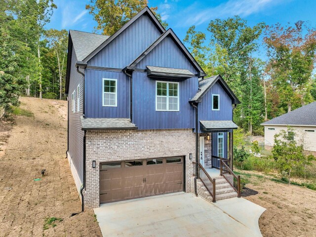 7592 Grasshopper Rd, Georgetown, TN 37336 - view of front of home with concrete driveway, a garage, roof with shingles, and brick siding