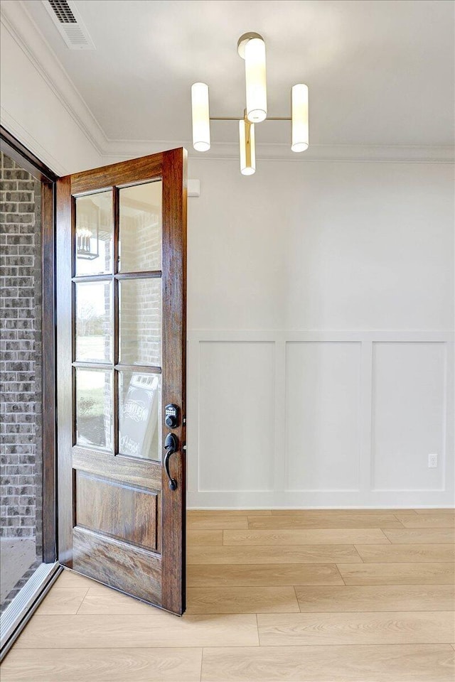 8650 Becket Way Lot # 4, Ooltewah, TN 37363 - doorway to outside with a decorative wall, ornamental molding, wainscoting, and wood finished floors