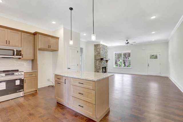 7383 Gamble Rd Lot # 5, Georgetown, TN 37336 - kitchen with appliances with stainless steel finishes, crown molding, a ceiling fan, a fireplace, and dark wood-style flooring