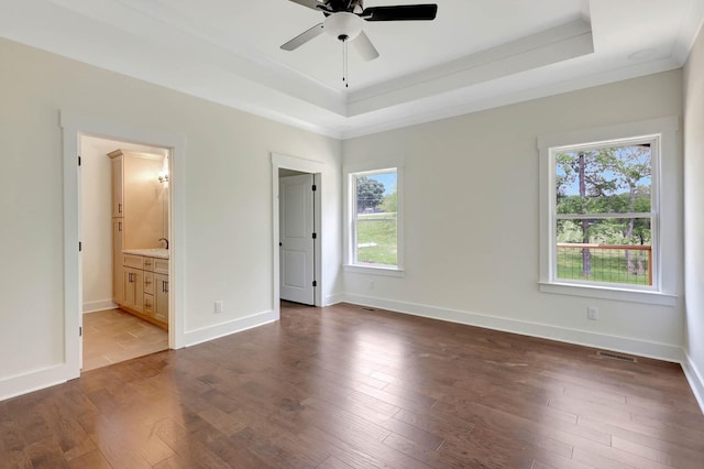7383 Gamble Rd Lot # 5, Georgetown, TN 37336 - unfurnished bedroom with a tray ceiling, multiple windows, ornamental molding, dark wood-style flooring, and ensuite bathroom