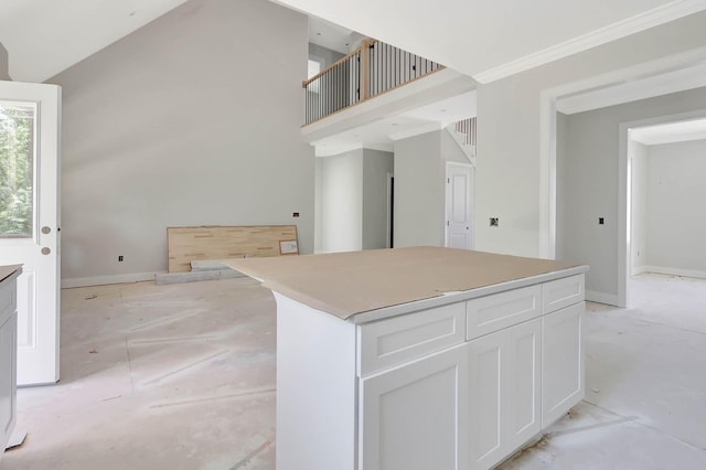 7452 Peytons Rise Way Lot # 52, Georgetown, TN 37336 - kitchen featuring a high ceiling, white cabinets, a center island, open floor plan, and baseboards