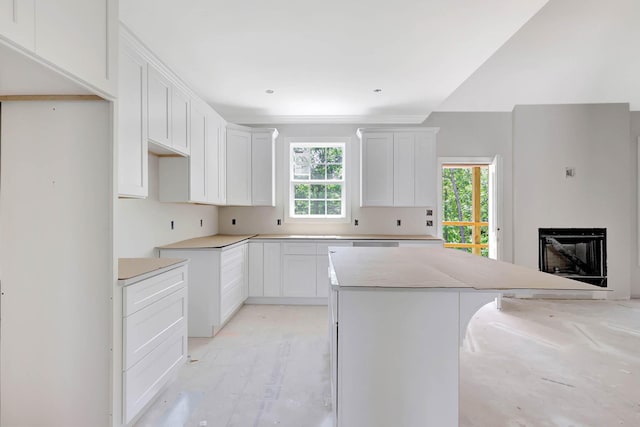 7452 Peytons Rise Way Lot # 52, Georgetown, TN 37336 - kitchen featuring a kitchen island, a fireplace, and white cabinetry
