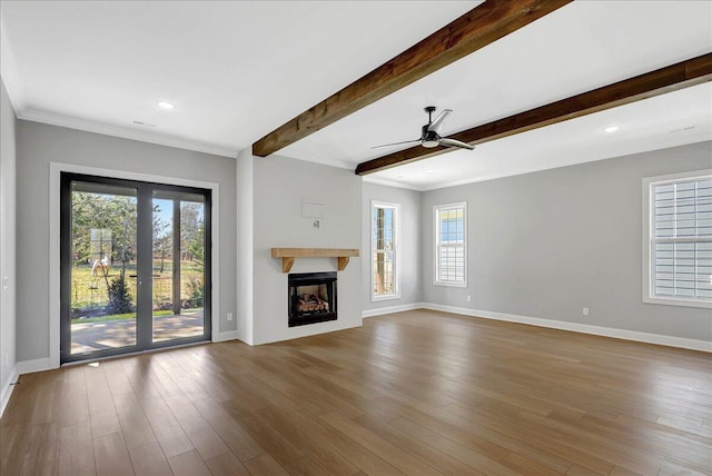8656 Becket Way Lot # 5, Ooltewah, TN 37363 - unfurnished living room with plenty of natural light, baseboards, beam ceiling, ornamental molding, and recessed lighting