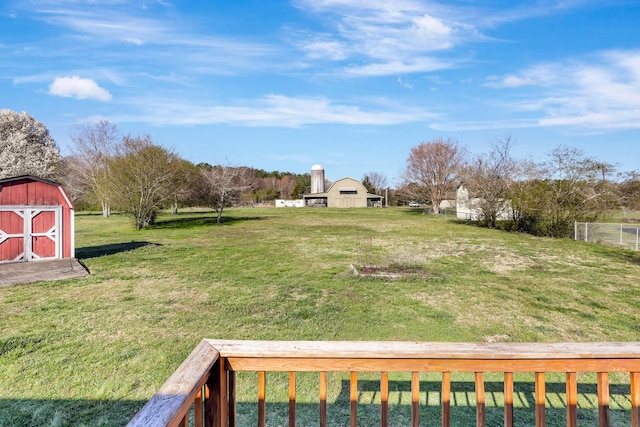 view of grassy yard with a shed and an outdoor structure